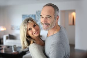 a man and a woman standing in a living room.